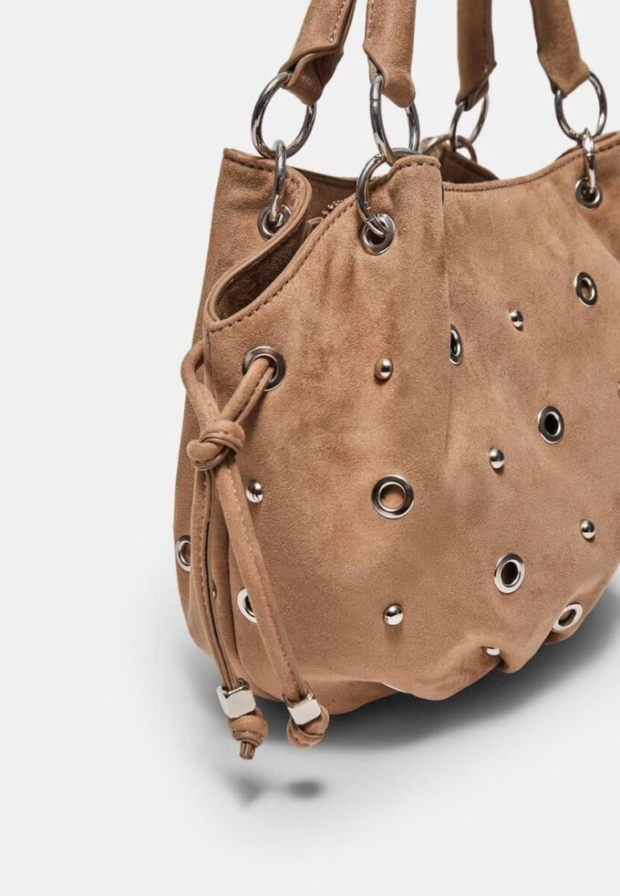 Rund crossbody-veske med øyedetaljer