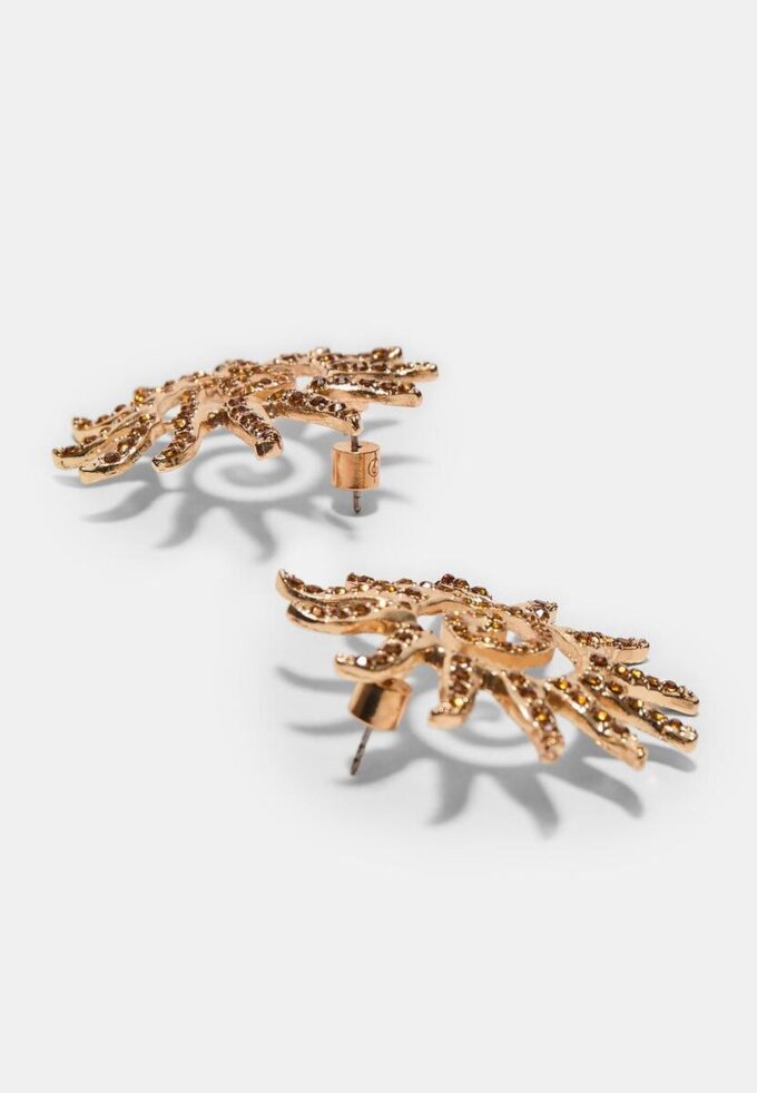 Små solformede strassøreringer